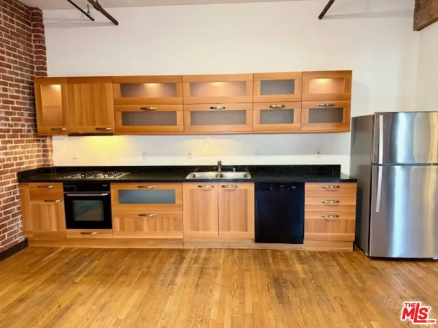 a kitchen with stainless steel appliances granite countertop a stove and a refrigerator