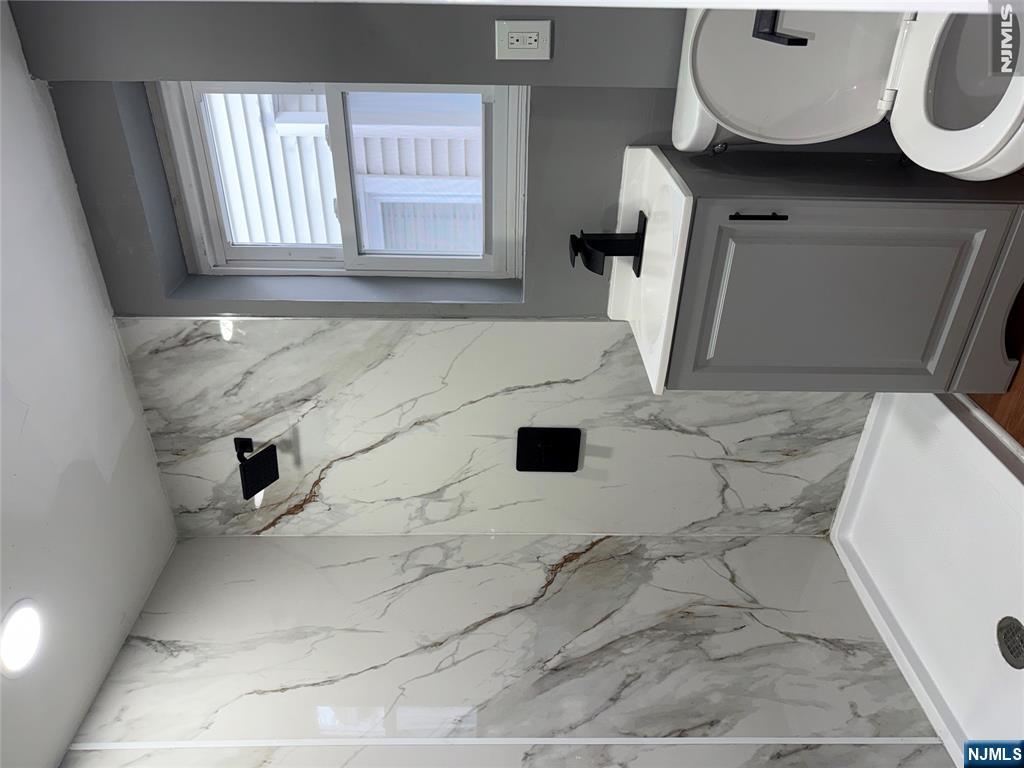 178 Berry Street Hackensack, NJ 07601 - Photo 14 of 22 a bathroom with a sink toilet and shower