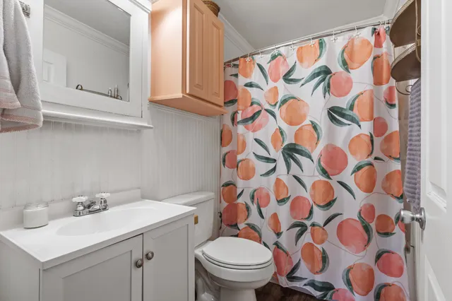 a bathroom with a sink and mirror with toilet