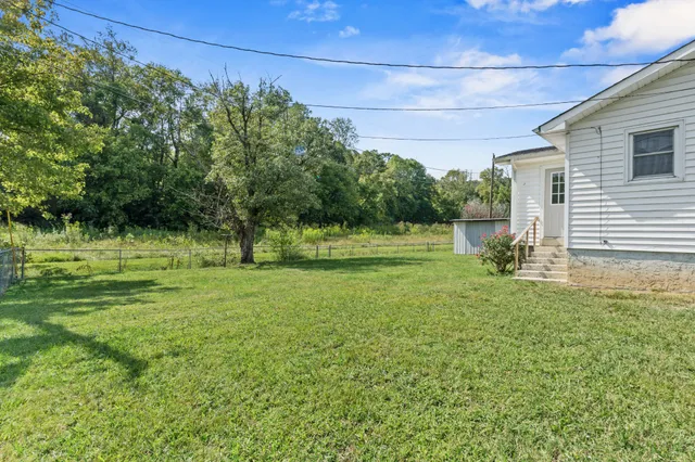 a backyard of a house with lots of green space