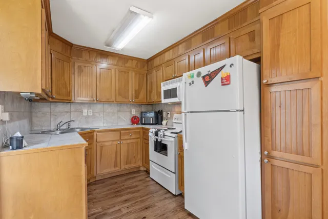a white refrigerator freezer sitting in a kitchen