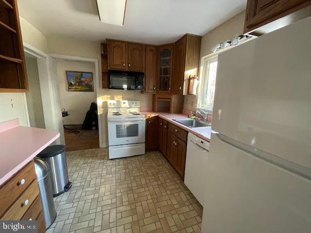 6211 Madawaska Road Bethesda, MD 20816 - Photo 11 of 24 a kitchen with stainless steel appliances a sink stove refrigerator and cabinets