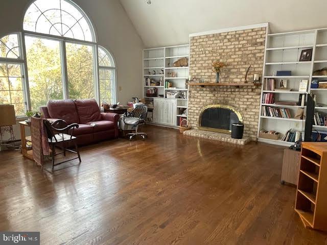 6211 Madawaska Road Bethesda, MD 20816 - Photo 5 of 24 a living room with furniture a fireplace and a floor to ceiling window