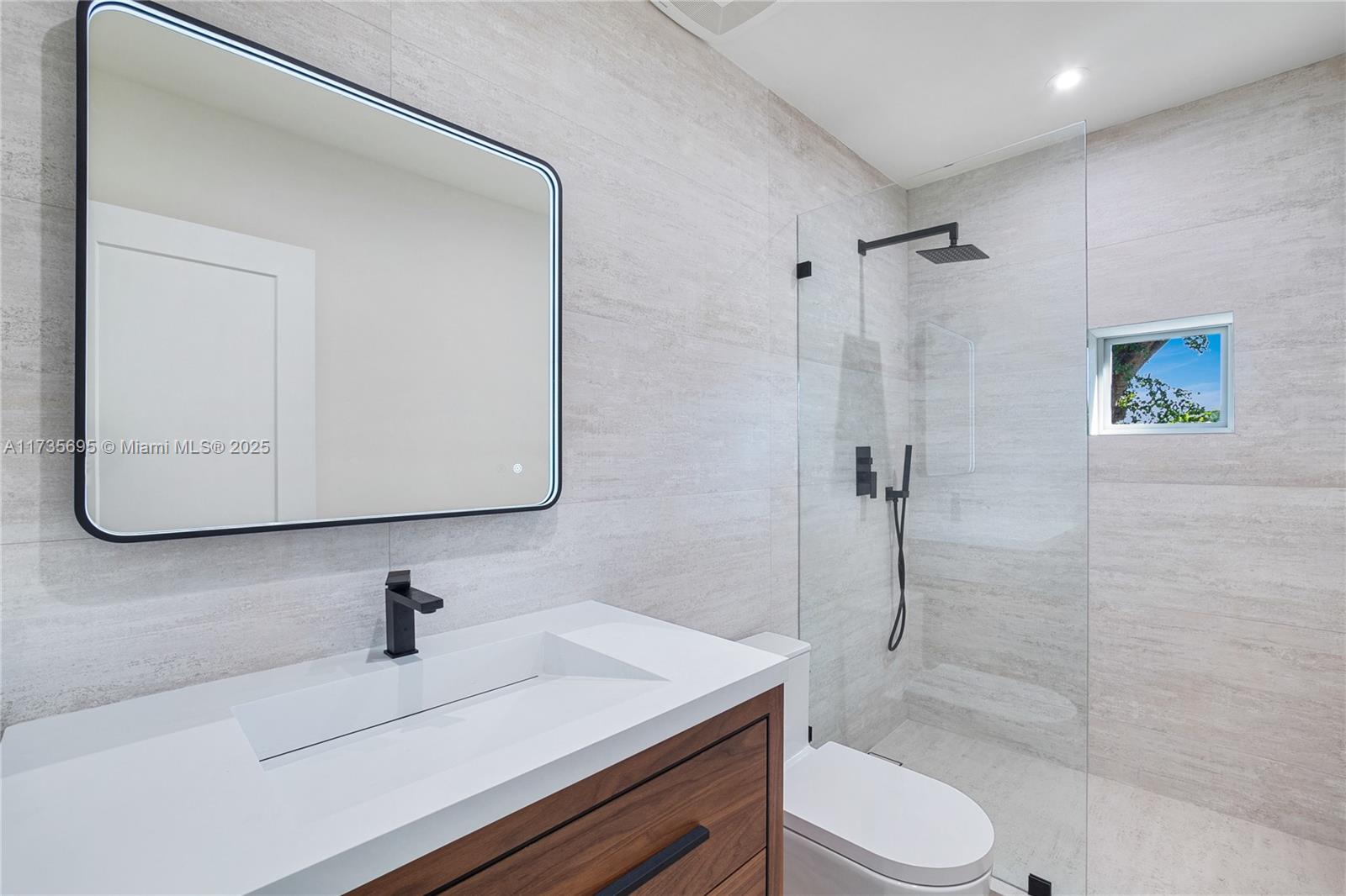 625 Jeronimo Drive Coral Gables, FL 33146 - Photo 25 of 30 a bathroom with a sink a toilet and shower