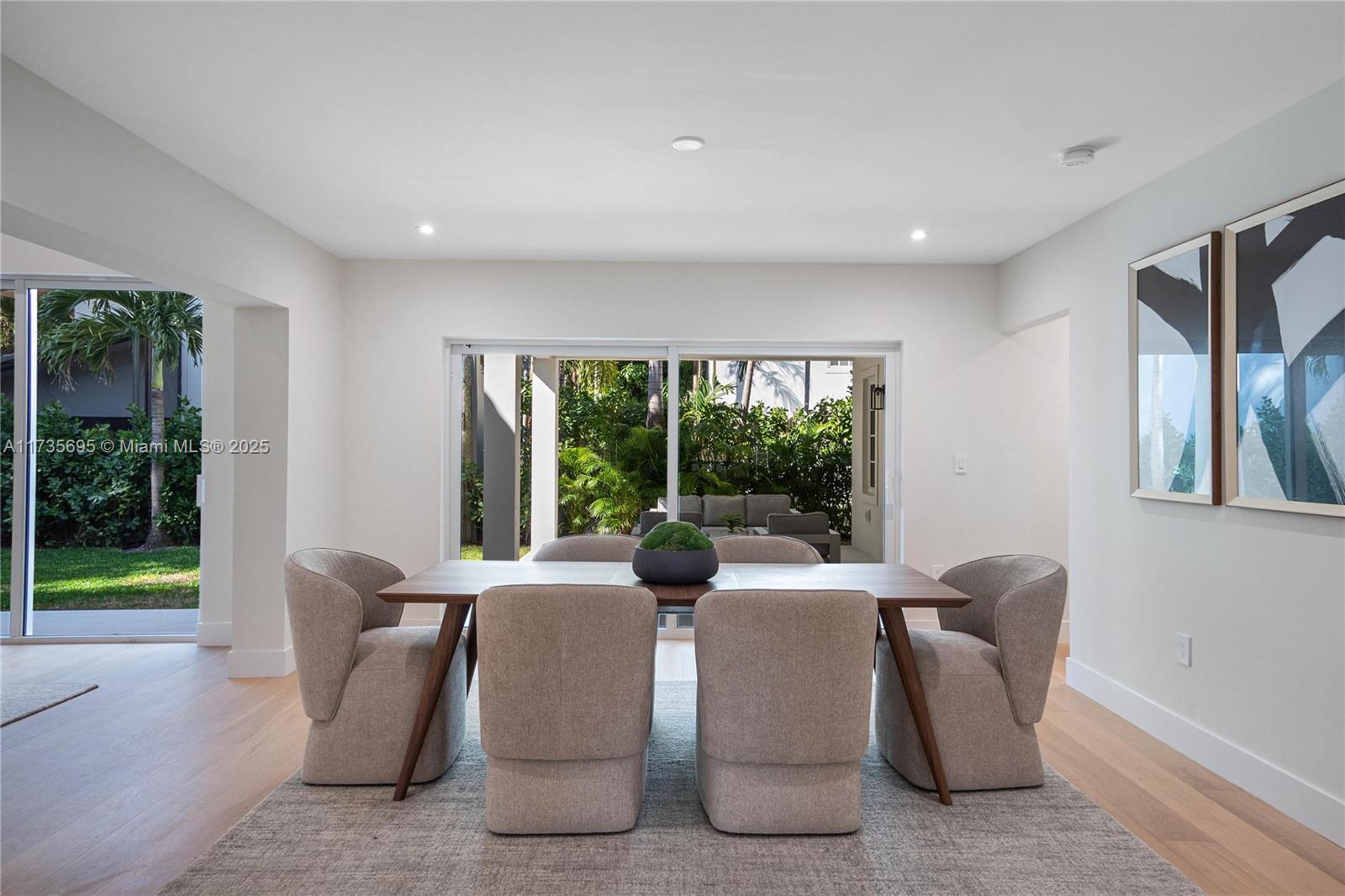 625 Jeronimo Drive Coral Gables, FL 33146 - Photo 5 of 30 a view of a dining room with furniture wooden floor and a potted plant