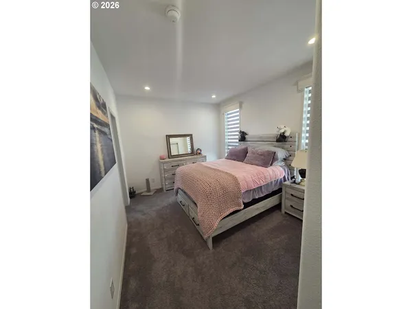 a bedroom with a bed and a mirror