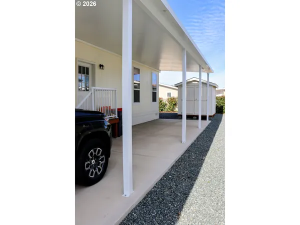 a view of an outdoor dining space with a table and chairs