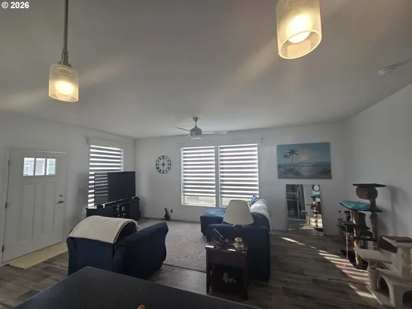 a living room with furniture chandelier and a window
