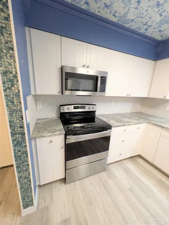 a kitchen with a stove and a microwave