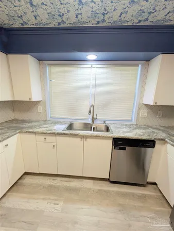 a kitchen with a sink and cabinets