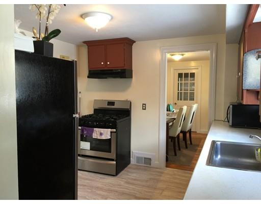 25 Hartwick Street Springfield, MA 01108 - Photo 5 of 18 a kitchen with stainless steel appliances granite countertop a refrigerator a stove and a sink with wooden floor
