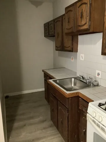 a kitchen with stainless steel appliances granite countertop a sink stove and microwave