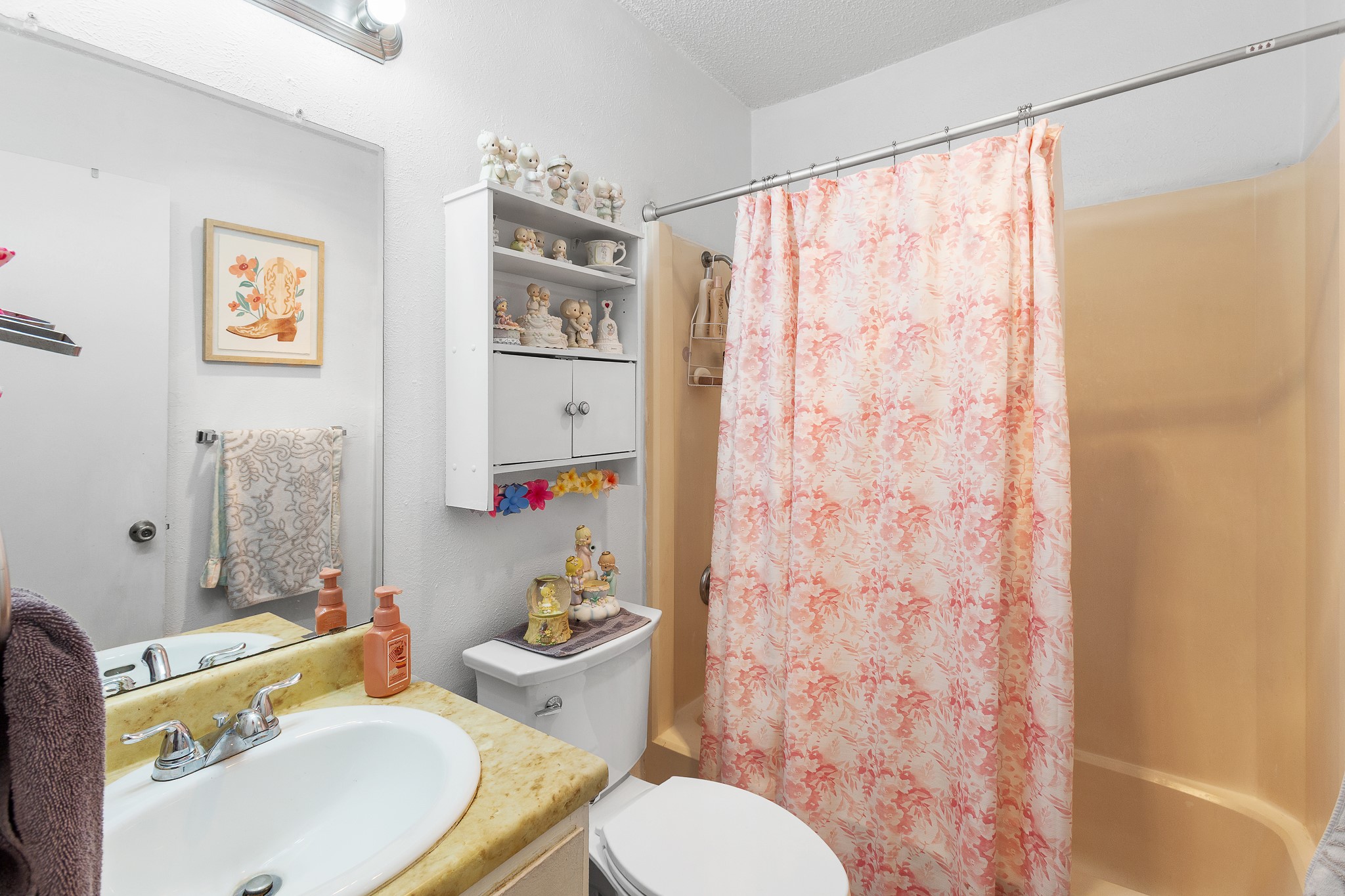 606 Misty Morning Way, Unit A AND B Round Rock, TX 78664 - Photo 17 of 22 Bathroom featuring vanity, shower / bath combination with curtain, and a textured ceiling