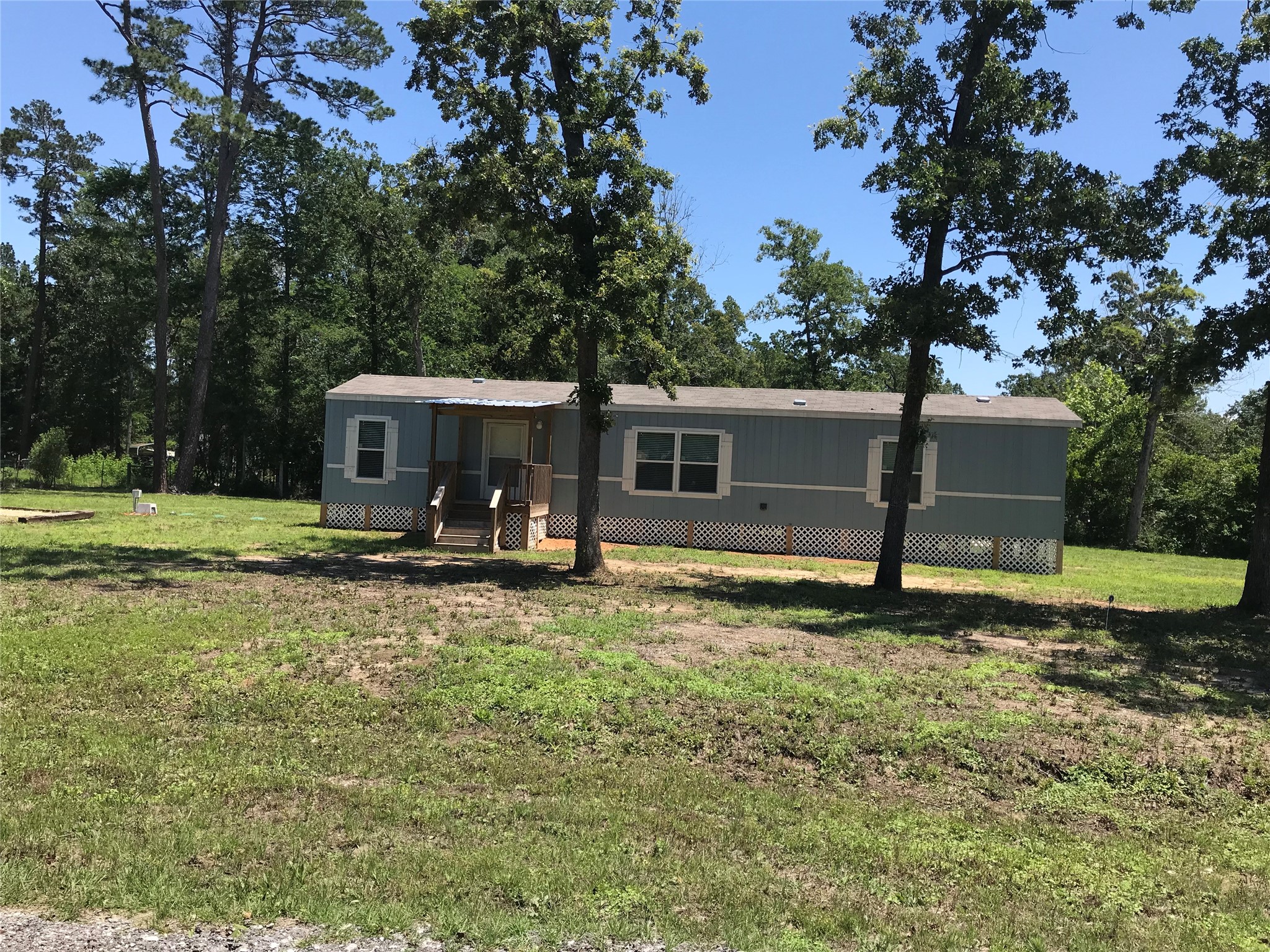 246 Brenda Road Trinity, TX 75862 - Photo 2 of 28 a view of a house with backyard porch and sitting area