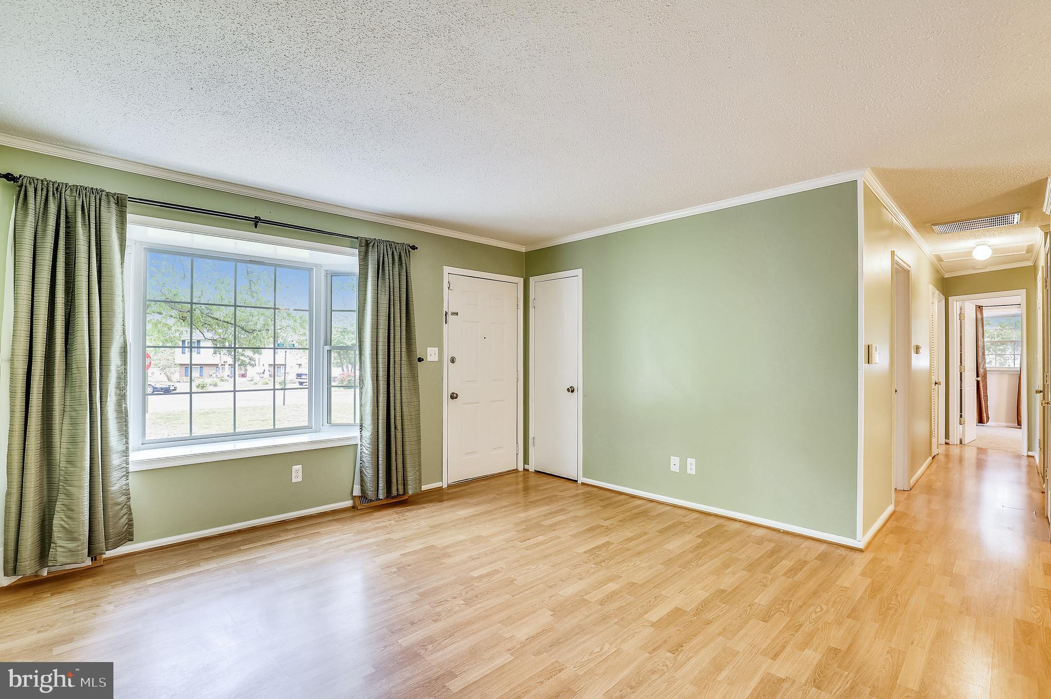 22012 Fox Ridge Road Lexington Park, MD 20653 - Photo 5 of 36 LIVING ROOM HAS WOOD LOOK LAMINATE FLOORING