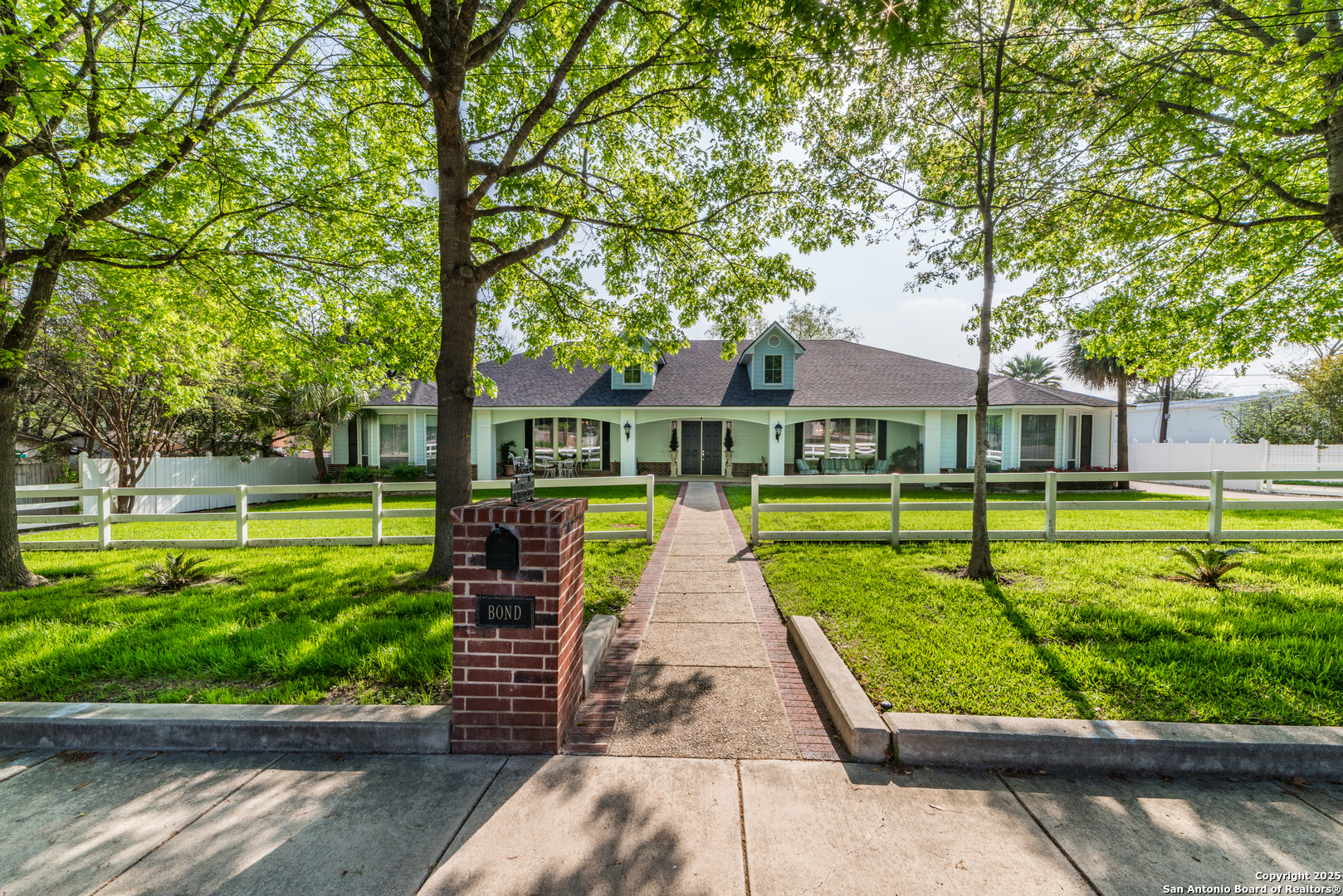7226 North Vandiver Road San Antonio, TX 78209 - Photo 2 of 59 a front view of a house with a yard table and chairs