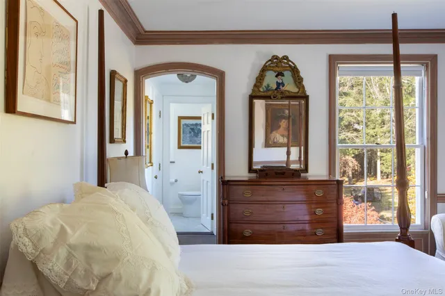 a bedroom with bed and wooden floor