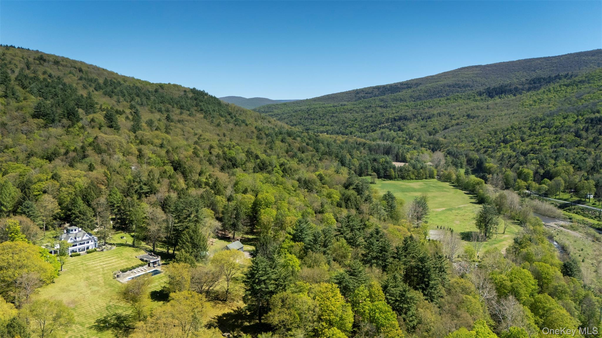 390 Erpf Road Arkville, NY 12406 - Photo 6 of 50 Drone / aerial view of stick and ball polo field and a mountain backdrop