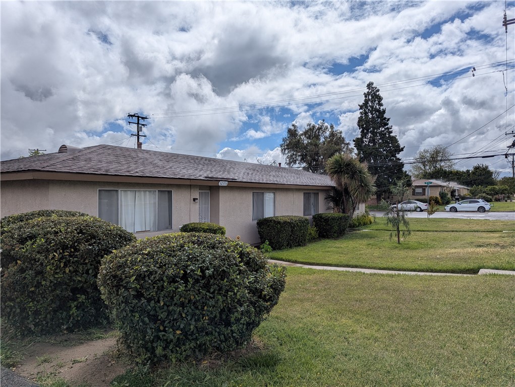 a view of a house with a garden and plants