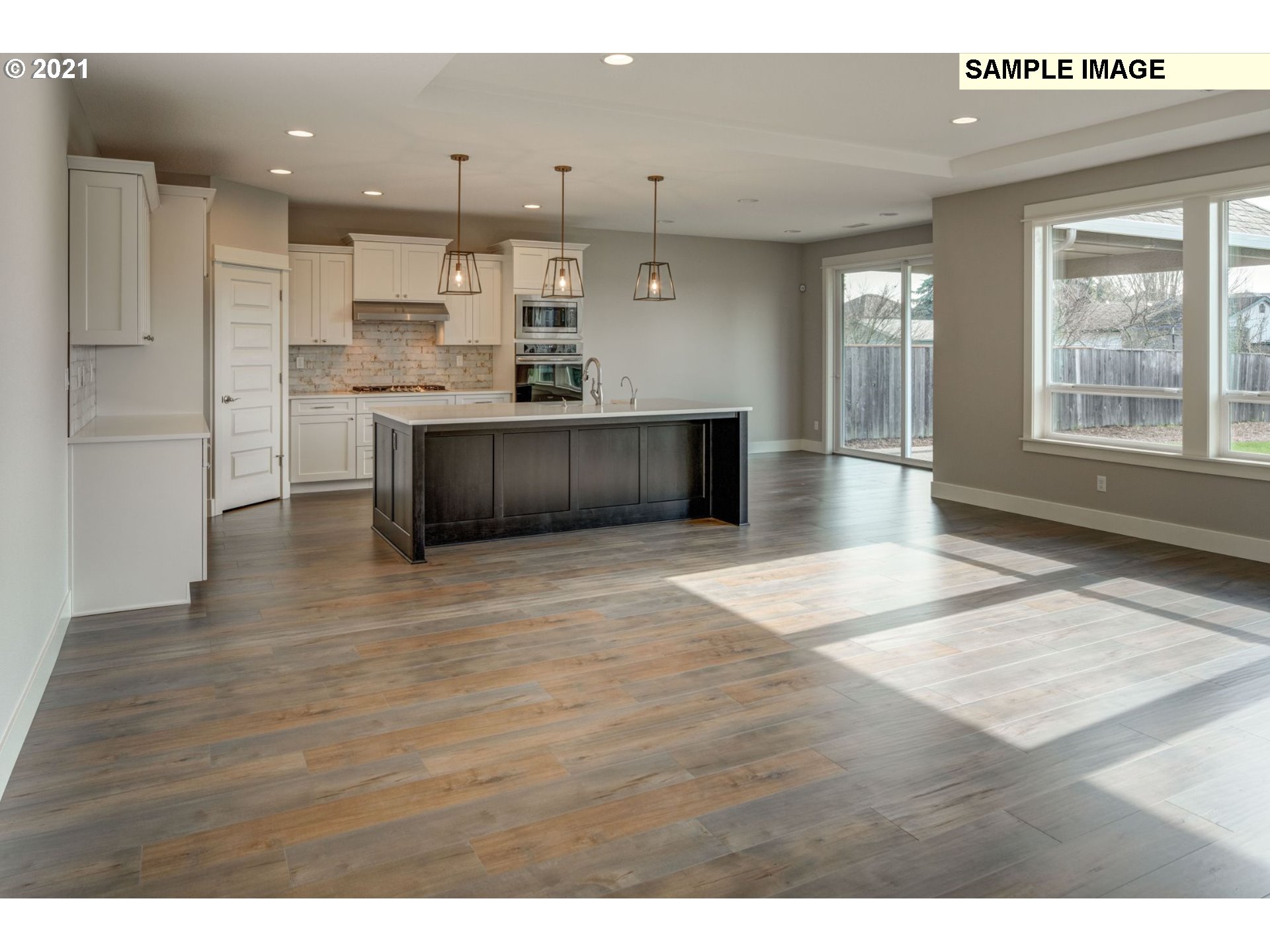 South Harper Valley Way Ridgefield, WA 98642 - Photo 6 of 24 a view of kitchen with kitchen island wooden floors appliances and cabinets