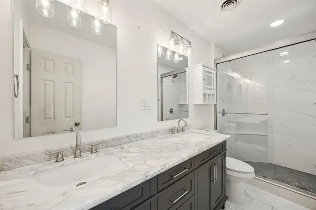 a bathroom with a sink a toilet and a mirror