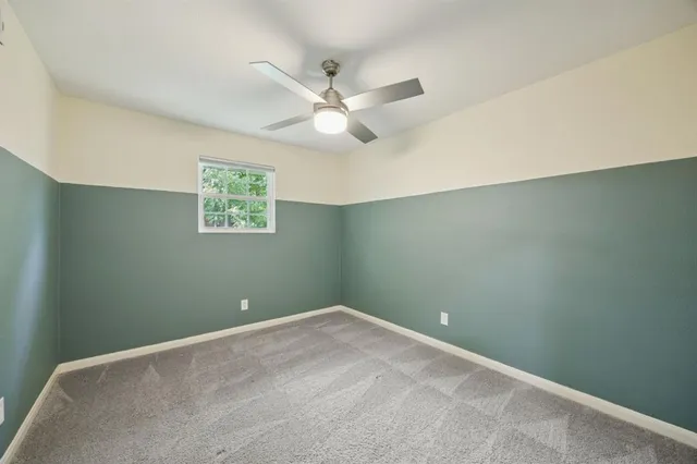 a bathroom with a granite countertop sink a mirror and a shower