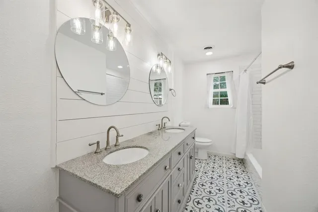 a bathroom with a sink double vanity and shower