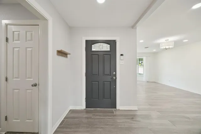 a view of a hallway with wooden floor