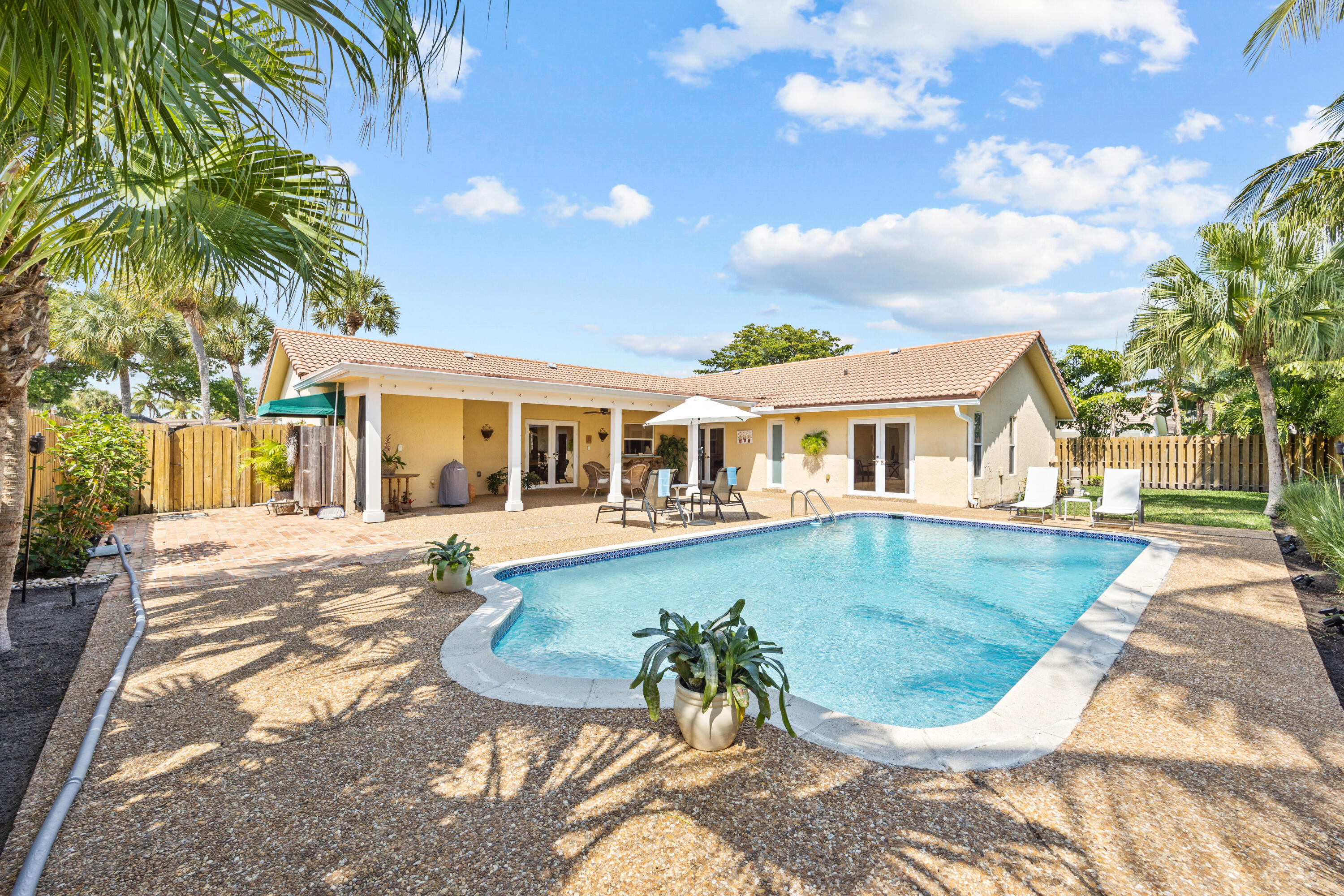 2136 Southwest 8th Avenue Boca Raton, FL 33486 - Photo 20 of 23 a view of a house with swimming pool and sitting area