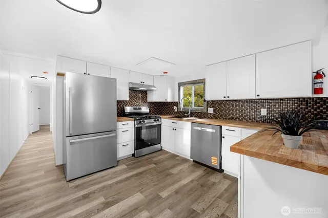 a kitchen with granite countertop a refrigerator and a sink
