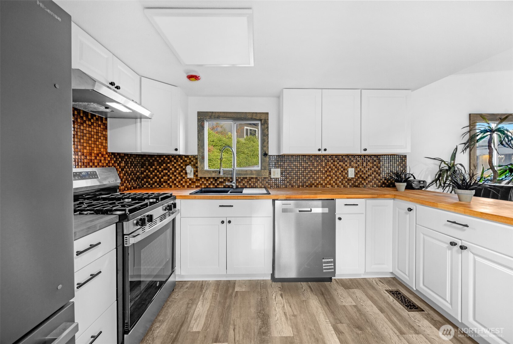 14322 Admiralty Way, Unit 8 Lynnwood, WA 98087 - Photo 5 of 21 a kitchen with a sink stove and cabinets