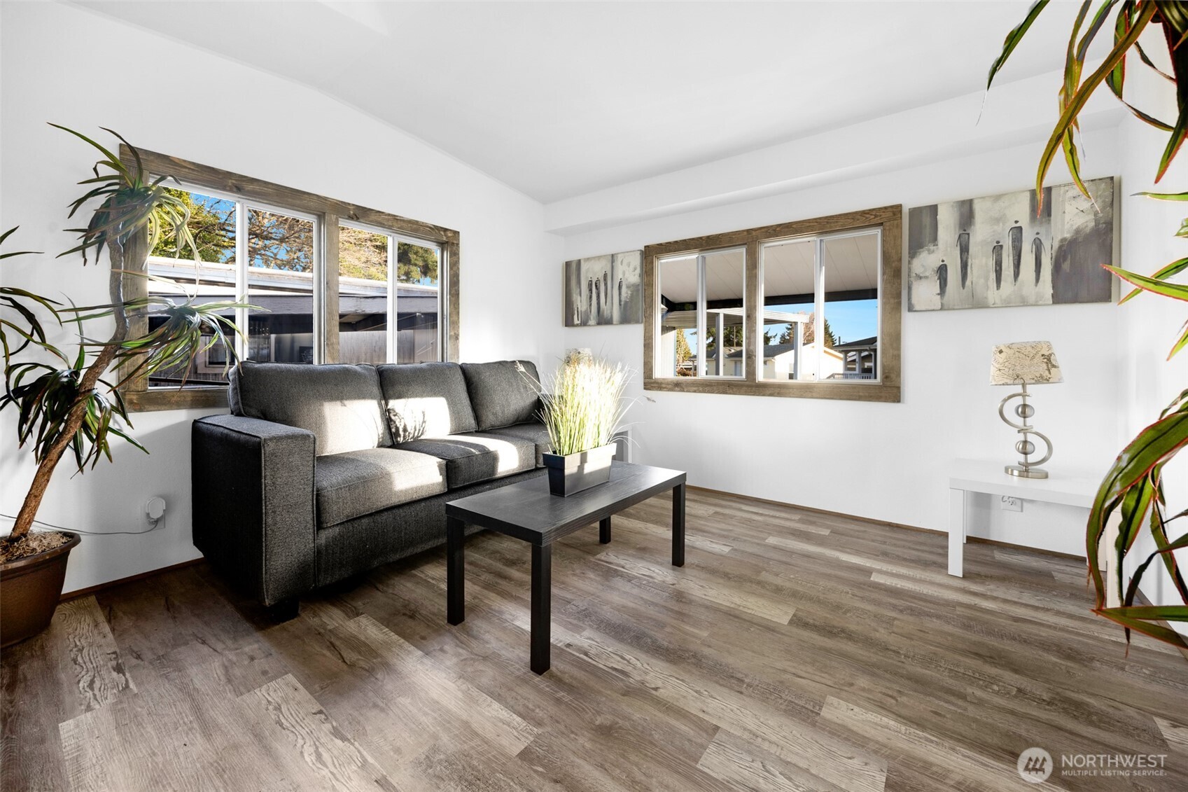 14322 Admiralty Way, Unit 8 Lynnwood, WA 98087 - Photo 7 of 21 a living room with furniture and a wooden floor