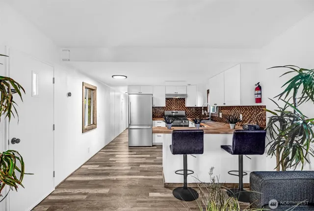 a living room with furniture a rug and a potted plant