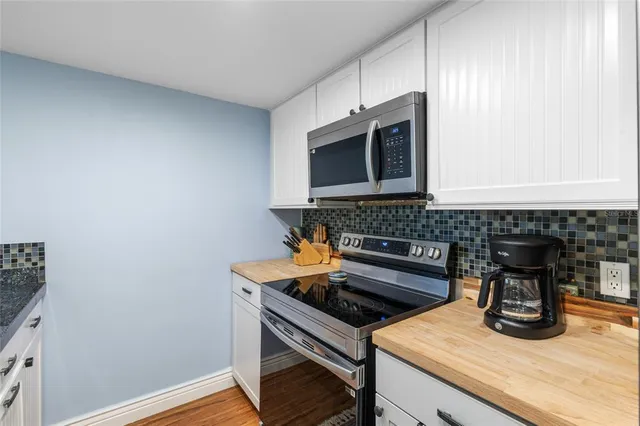 a kitchen with a stove and a microwave