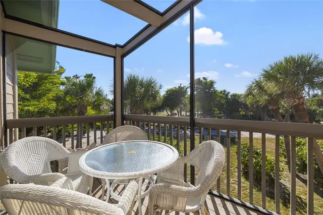 a balcony with table and chairs