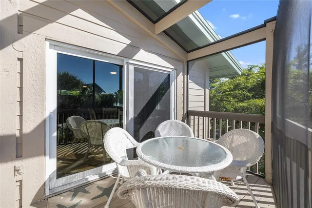 a balcony with table and chairs