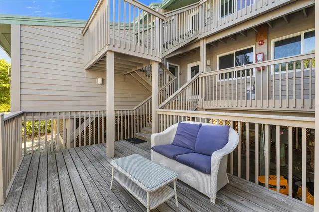 a view of a house with a deck and furniture