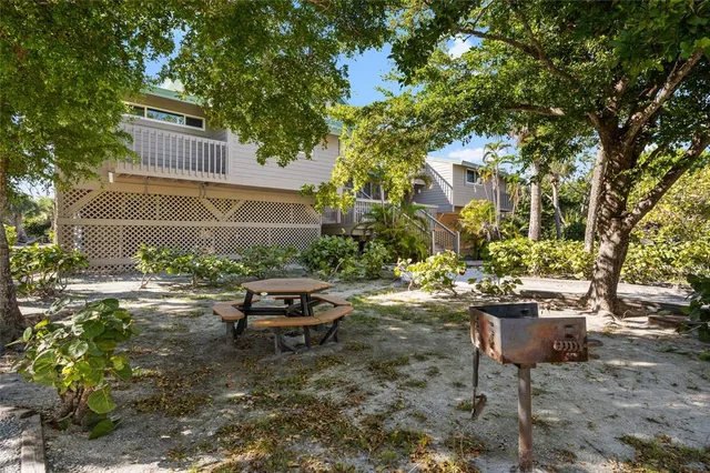 a backyard of a house with yard and outdoor seating