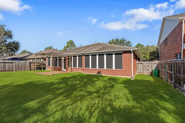 a view of a house with backyard and sitting area