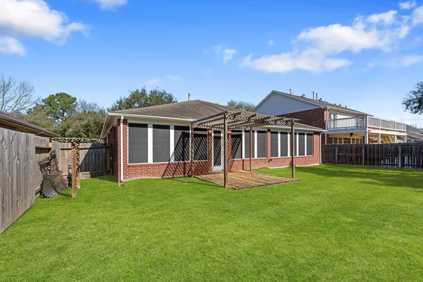 a view of a house with a yard and sitting area