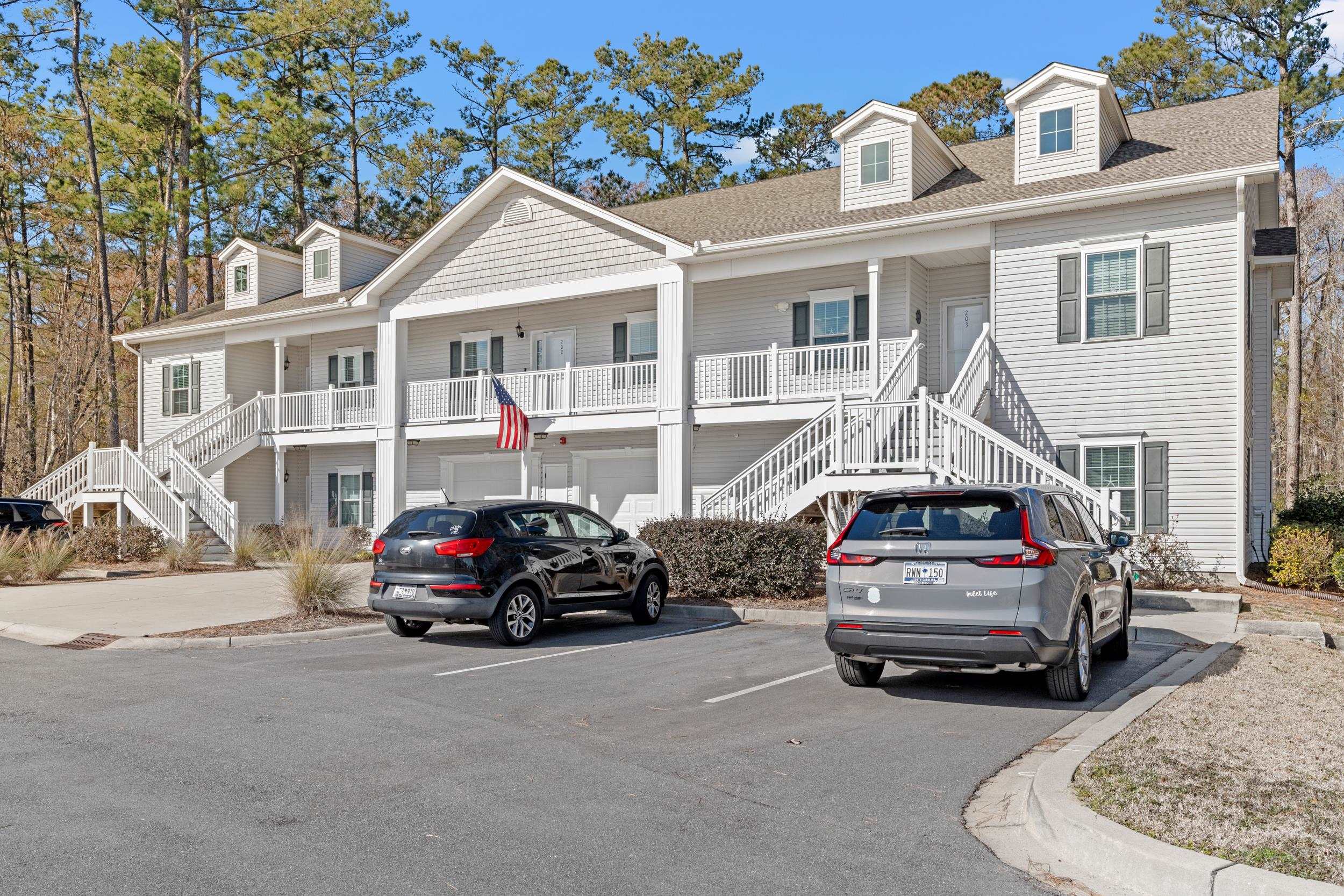 900 Jackline Place, Unit 202 Columbia, SC 29209 - Photo 12 of 39 View of front of home featuring stairway, covered porch, uncovered parking, and a shingled roof