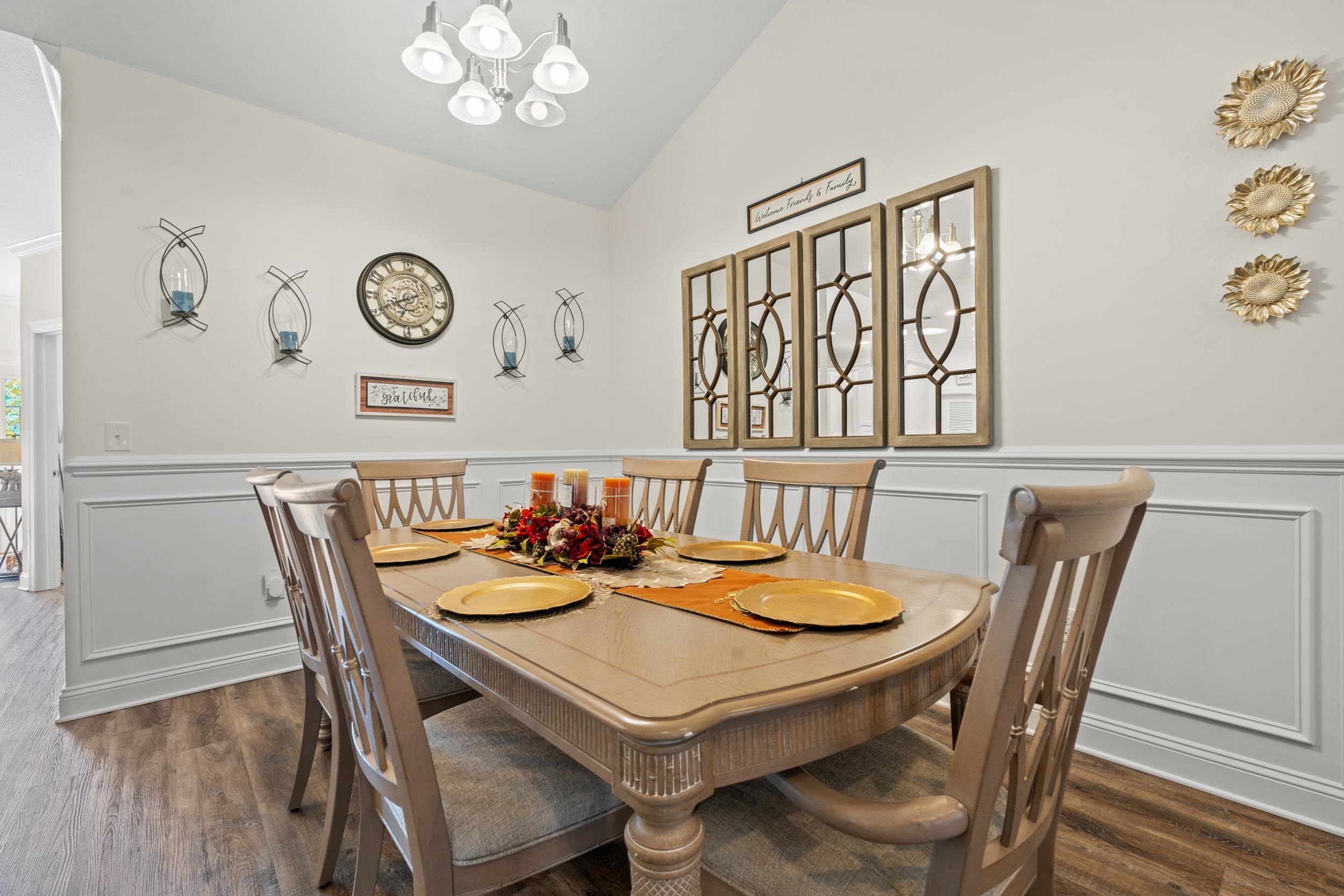 900 Jackline Place, Unit 202 Columbia, SC 29209 - Photo 4 of 39 Dining room featuring a wainscoted wall, a decorative wall, lofted ceiling, a chandelier, and dark wood-style flooring