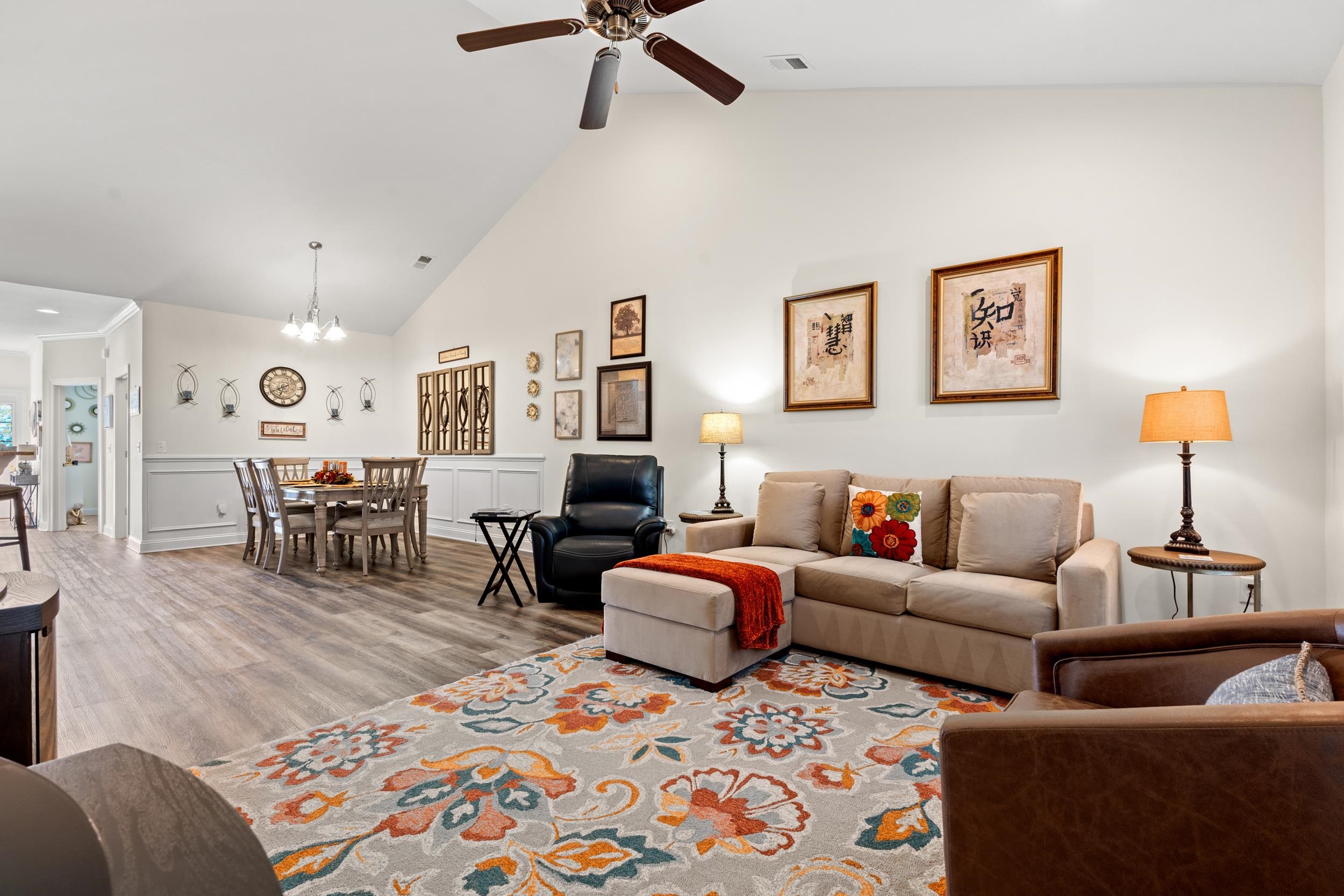 900 Jackline Place, Unit 202 Columbia, SC 29209 - Photo 5 of 39 Living area with wood finished floors, a chandelier, high vaulted ceiling, a decorative wall, and a wainscoted wall