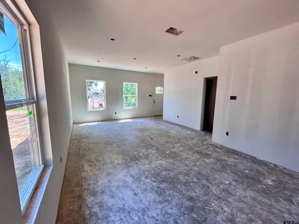 a view of livingroom with window and stairs