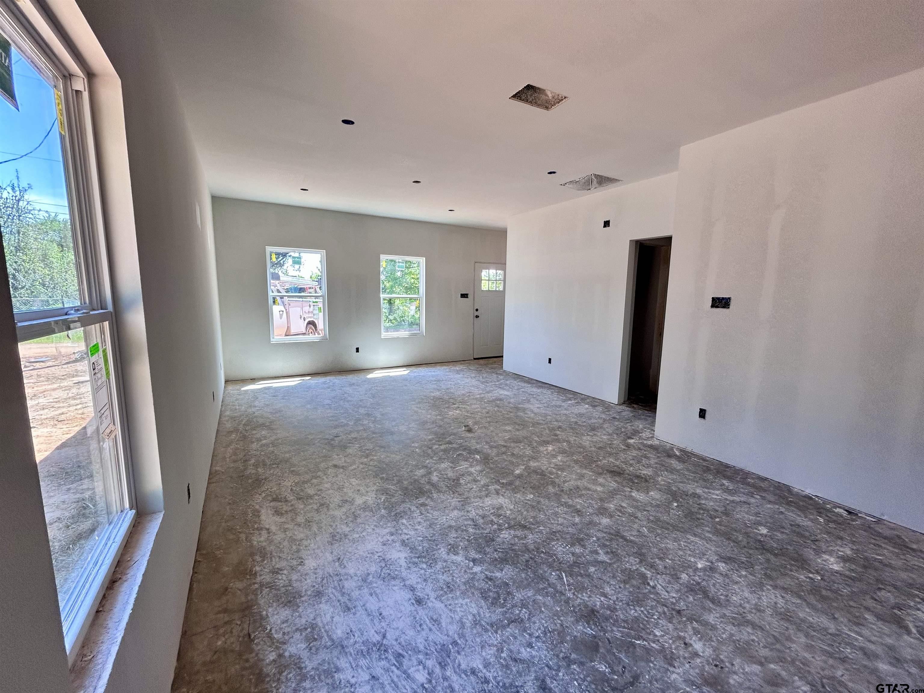 201 East Fleming Street Longview, TX 75604 - Photo 3 of 13 a view of livingroom with window and stairs