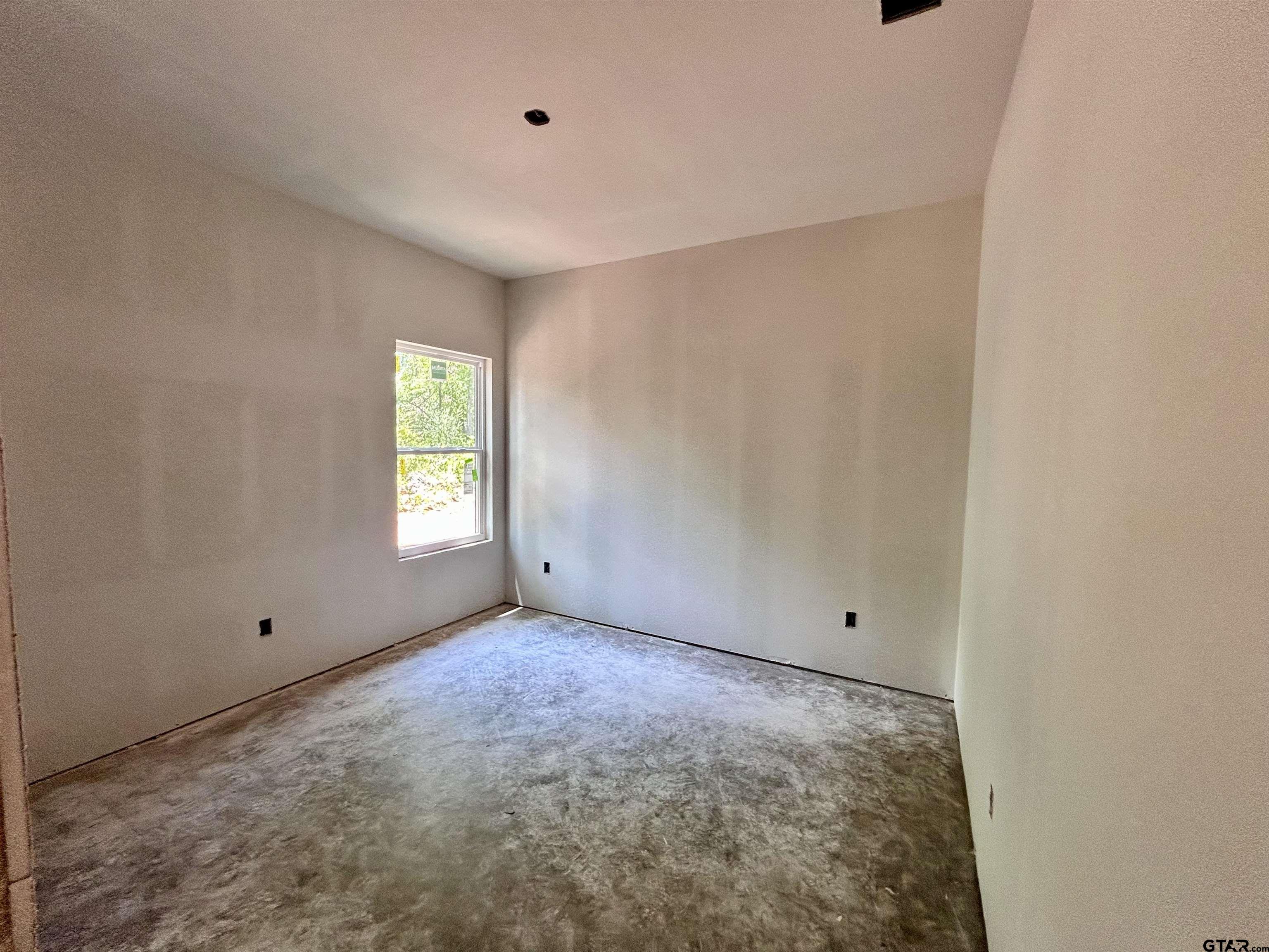 201 East Fleming Street Longview, TX 75604 - Photo 8 of 13 a view of an empty room with a window