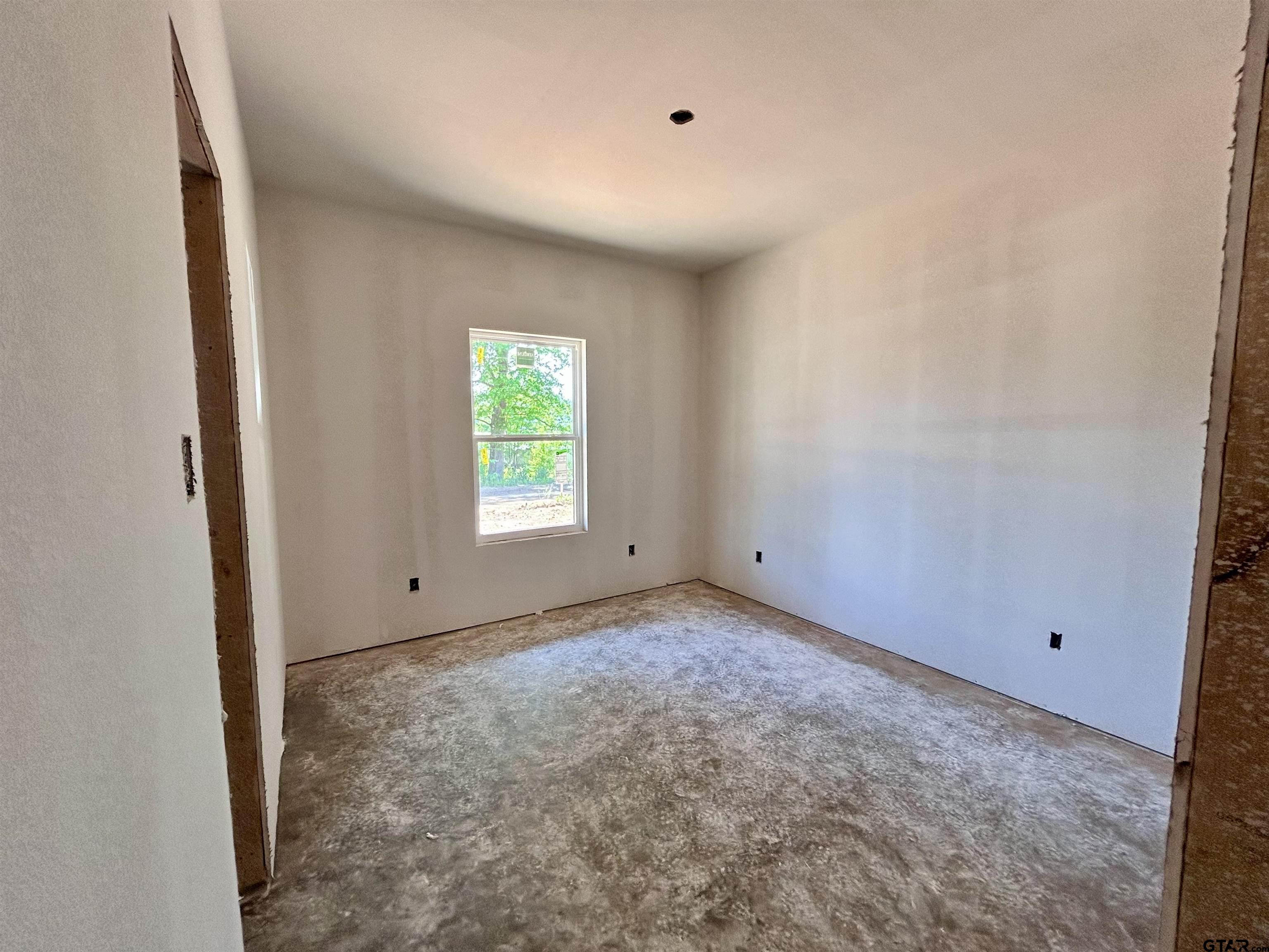 201 East Fleming Street Longview, TX 75604 - Photo 9 of 13 a view of an empty room with a window