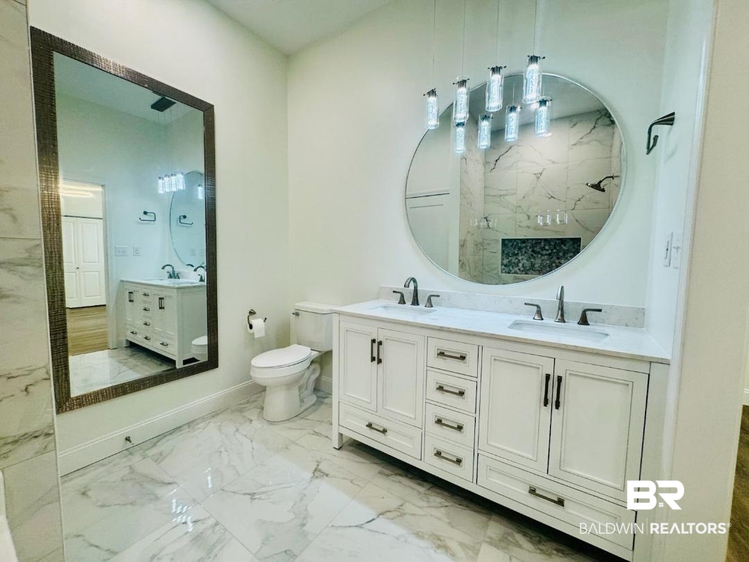 2663 Demetropolis Road Mobile, AL 36693 - Photo 17 of 26 Bathroom with marble finish flooring, double vanity, and a marble finish shower
