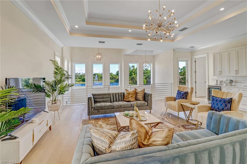 2875 Coco Lakes Drive Naples, FL 34105 - Photo 14 of 27 a living room with furniture and a chandelier