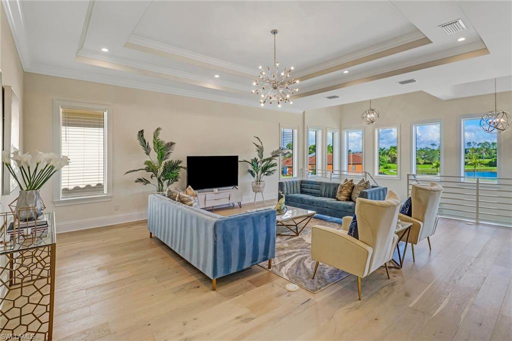 2875 Coco Lakes Drive Naples, FL 34105 - Photo 15 of 27 a living room with furniture and a flat screen tv